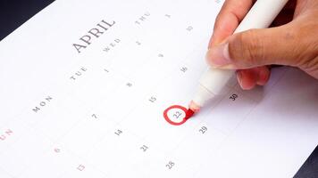 Red circle marked on a calendar at 22 of April as symbol of important day photo