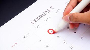 Red circle marked on a calendar at 4 of February as symbol of important day photo