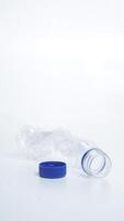 Empty crumpled plastic bottle waste isolated on white background photo
