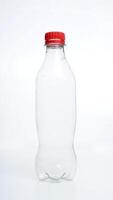 Empty plastic bottle with red bottle cap isolated on white background photo