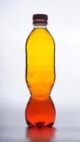 Yellow mixed orange colored water in plastic bottle with brown bottle cap isolated on white background photo