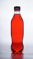 Red colored water in plastic bottle with brown bottle cap isolated on white background photo