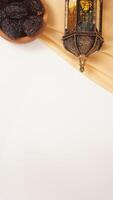 Muslim decoration for Ramadan and Eid al-Fitr with holy Quran, islamic lantern, and beige fabric isolated on white background photo
