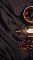 Various kind of decorations for Eid al-Fitr and Ramadan on black fabric background photo