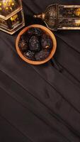 Elegance muslim decoration for Eid al-Fitr and Ramadan on black fabric background photo