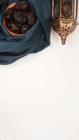 Beautiful muslim decoration for Ramadan and Eid al-Fitr with dark green fabric isolated on light background photo