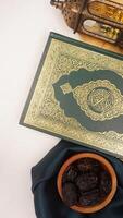 Various kind of decorations for Ramadan and Eid al-Fitr with dark green fabric isolated on light background photo