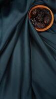 Muslim decoration for Ramadan and Eid al-Fitr isolated on dark green fabric background photo