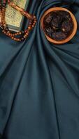 Muslim decoration for Eid al-Fitr and Ramadan isolated on dark green fabric background photo