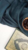 Various kind of decorations for Eid al-Fitr and Ramadan with dark green fabric isolated on light background photo