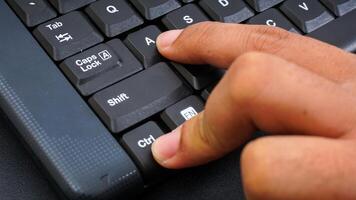 Close up on finger pressing ctrl or control and A shortcut keys on a computer keyboard for select all isolated on black background photo