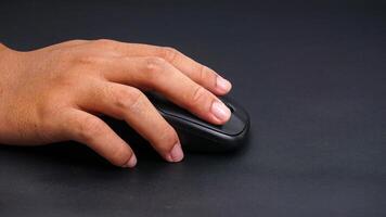 Man hand holding computer mouse isolated on black background photo