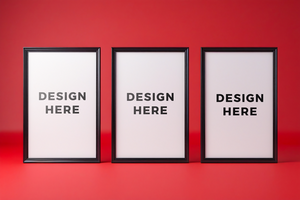 Three poster mockup with black frame against red background for art placement psd