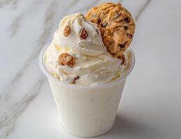 A delicious cookie milkshake with whipped cream and a chocolate chip cookie photo