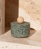 Minimalist product display featuring a round soap bar on a textured pedestal photo