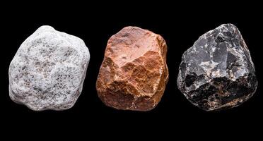 Three rocks of different colors in a line on a black background. photo