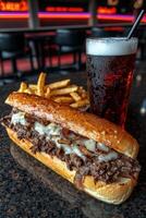 A delicious cheesesteak sandwich with fries and a soda photo