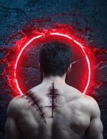 Man with scars on his back standing in front of a glowing red circle photo