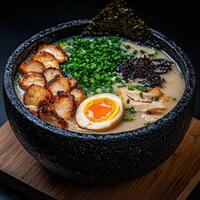 A delicious bowl of ramen with egg, chicken, and seaweed photo