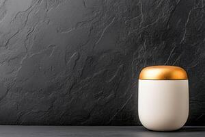 sleek electronic container with golden lid sits elegantly against textured black background, showcasing modern design and style photo