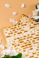 Spring flowers and matzo bread on beige background photo