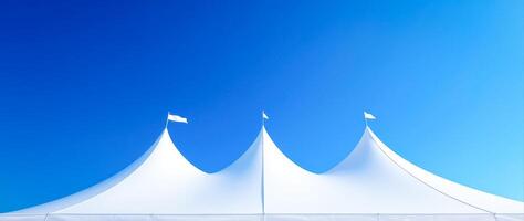 three white party tents set against a vibrant blue sky photo