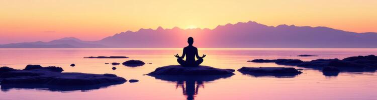 silhouette of a person meditating on a rock at sunset by the sea photo