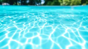 abstract of sunlight on the surface of a turquoise swimming pool photo