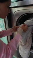 Washing Process The Steps Involved in Loading a Laundry Machine with a Towel for Cleaning video