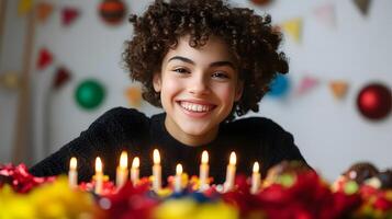 A smiling young woman with curly hair enthusiastically lighting a set of colorful candles surrounded by festive a cheerful and warm scene photo
