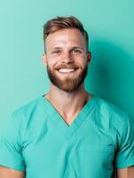 Friendly and approachable portrait of a young male healthcare professional in medical scrubs smiling confidently as a physical therapy assistant photo