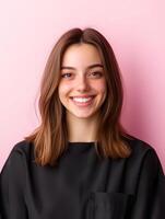 Portrait of a confident and charismatic young woman with stylish hair smiling warmly against a colorful pink background photo