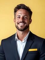 Portrait of a confident and charismatic cruise director posing in a formal business suit and smiling against a yellow background photo