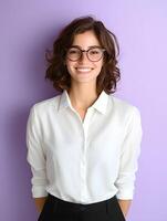 Portrait of a young smiling woman with curly hair wearing glasses and a white shirt against a purple background photo