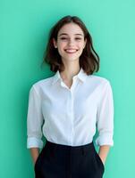 A young smiling woman in a white blouse poses for a portrait photo