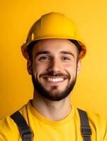 Portrait of a smiling construction worker in a yellow hardhat photo