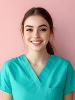 Portrait of a smiling young nurse in a teal uniform photo