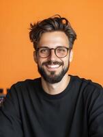 Smiling man with glasses and beard in casual black outfit photo