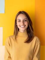 Portrait of a smiling young interior designer against a vibrant yellow wall photo