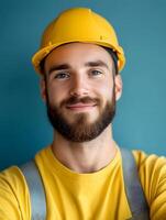 Portrait of a young smiling carpenter in a hardhat photo