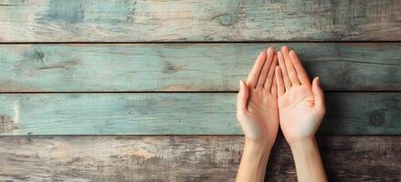 Hands in Prayer Gesture on Weathered Wooden Planks Background photo