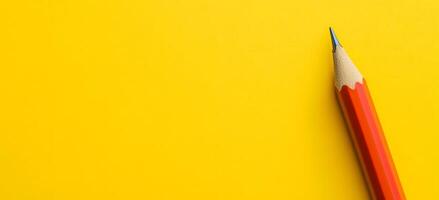 Sharp Yellow Pencil on Vibrant Yellow Background for Creative and Educational Concepts photo