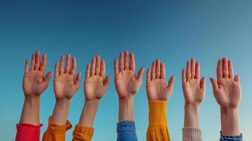 A diverse group of people raising their hands in a gesture of support for LGBTQ rights and during a public or rally photo