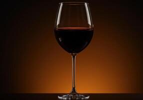A perfectly poured glass of red wine stands ready for a toast, bathed in soft light. photo