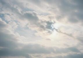 A sky filled with soft clouds where the sun's gentle glow creates a serene vista. photo