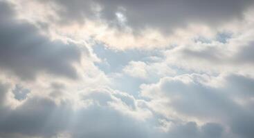 Sun rays break through the clouds, creating a tranquil and bright skyscape. photo
