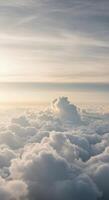 An aerial view over a serene sea of clouds illuminated by soft, diffused sunlight. photo