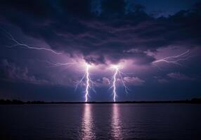 Powerful lightning illuminates the night sky during a fierce thunderstorm over the water. photo