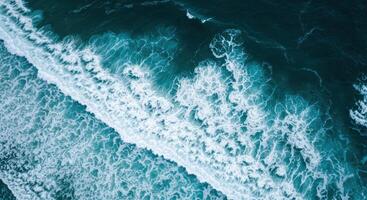 Turquoise ocean waves create a mesmerizing pattern as they crash against the coastline. photo