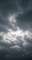 Moody storm clouds fill the sky, with a small patch of blue peeking through. photo